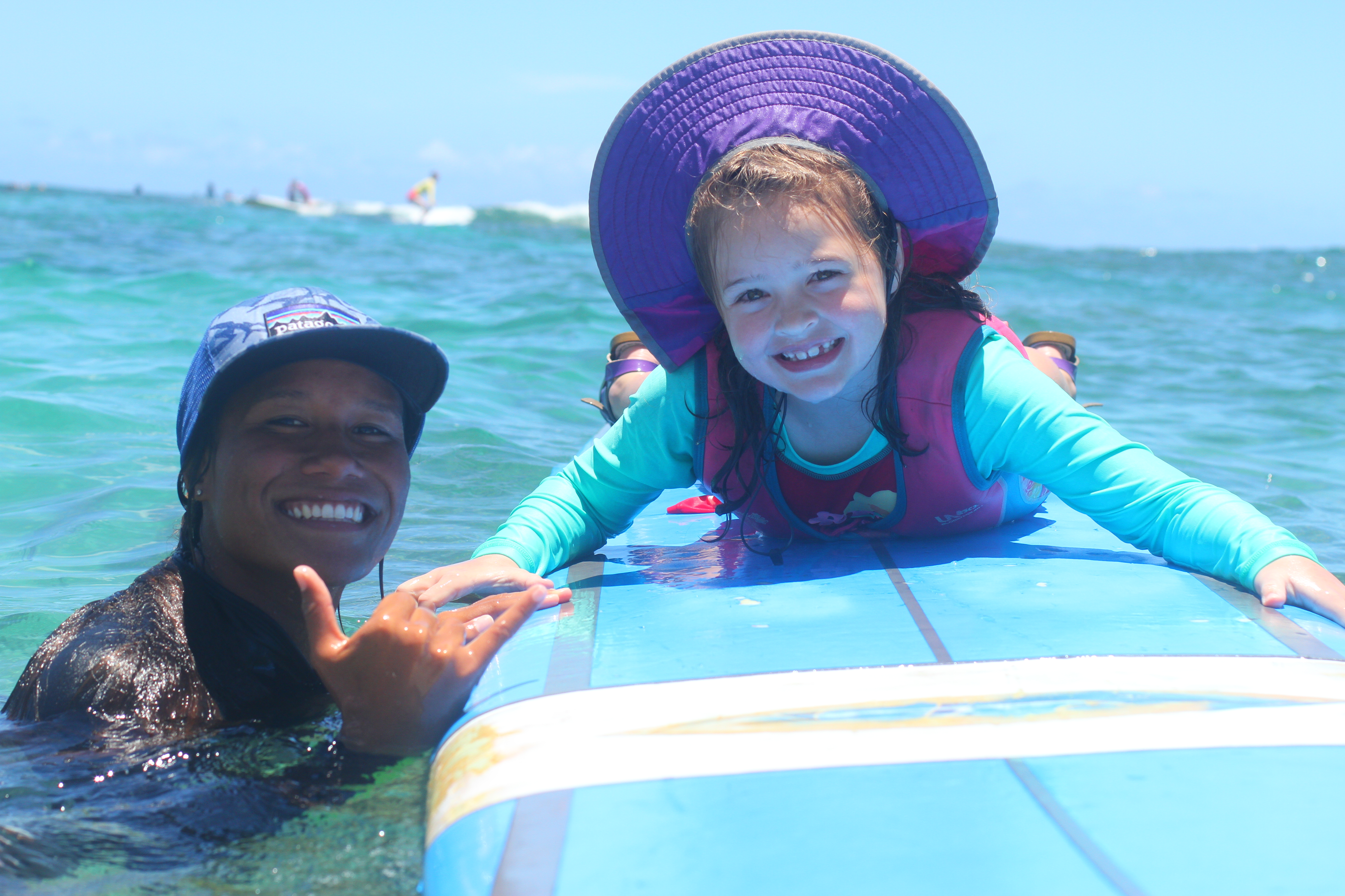 young surf student with instructor